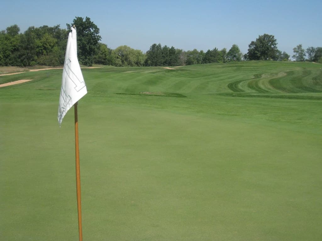 Putting green and fairway corridor at Erin Hills