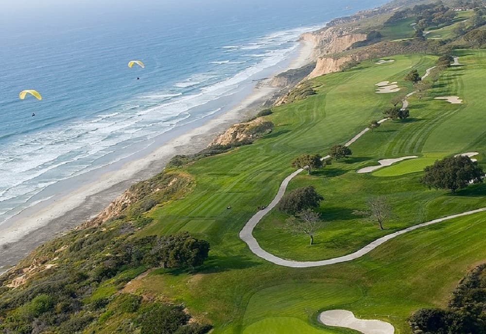 Aerial view of Torrey Pines fairways on coastal cliffs above the Pacific