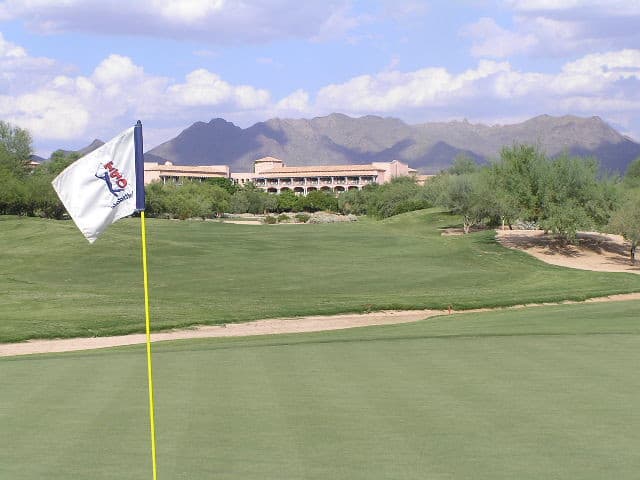 TPC Scottsdale fairway, desert vegetation, and resort mountains