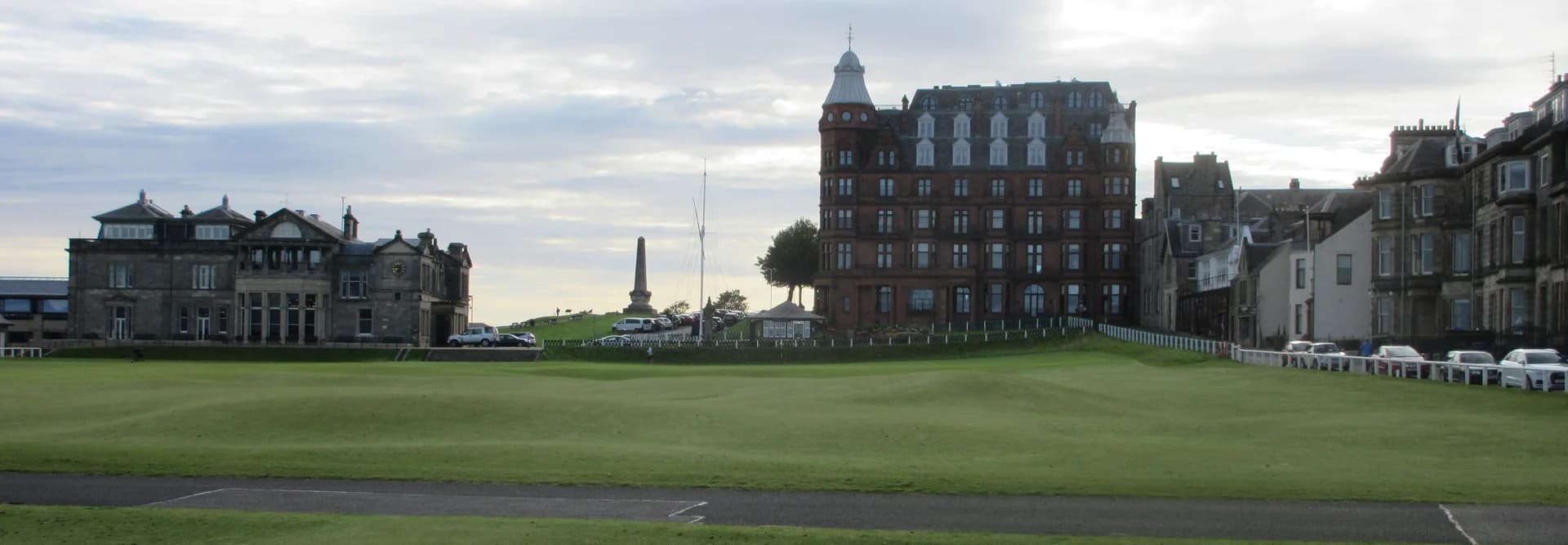 The 18th fairway and green of the Old Course at St Andrews, with historic buildings beyond